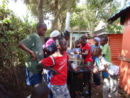 Trying out the wood burning cooker: plenty of interest!